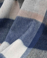 A close-up view of a blue and gray plaid winter scarf, showcasing its intricate pattern and soft texture.