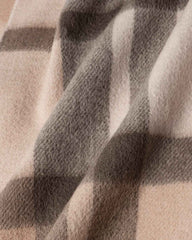 A close-up view of a coffee and gray plaid winter scarf, showcasing its intricate pattern and soft texture.