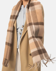 A model showcases a large wool scarf in coffee and gray plaid, perfect for winter styling.