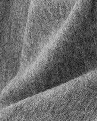 Close-up of a gray wool fabric, showcasing the texture and warmth ideal for a winter scarf.