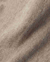 Close-up of a khaki wool fabric, showcasing the texture and warmth ideal for a winter scarf.