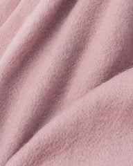 Close-up of a pink wool fabric, showcasing the texture and warmth ideal for a winter scarf.