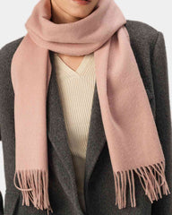 A model showcases a stylish pink winter scarf, demonstrating a fashionable way to wear a scarf.