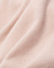 Close-up of a light beige women's scarf, showcasing its soft fabric texture and elegant drape.