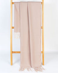 A beige women's scarf and shawl draped elegantly over a wooden stand.