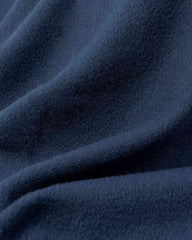 Close-up of a navy blue fabric, showcasing the texture of a luxurious scarf or shawl.