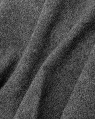 Close-up of a dark gray fabric, showcasing the texture of a scarf or shawl.