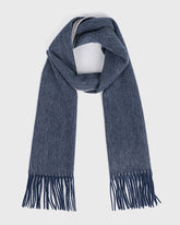 A reversible blue wool scarf with fringes, showcasing a soft texture and elegant design.