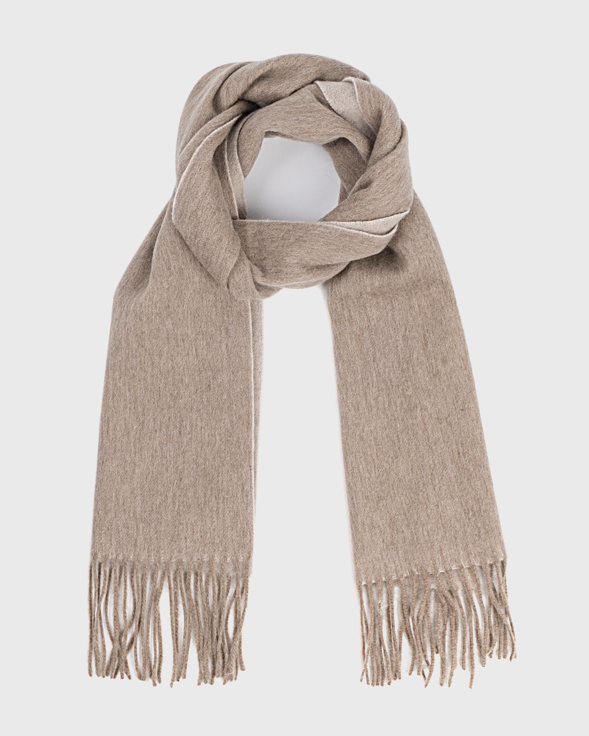 A khaki reversible scarf featuring fringes, elegantly draped to showcase its soft khaki texture.