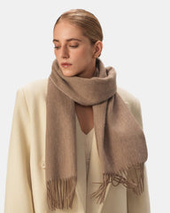 A soft khaki wool scarf elegantly draped, showcasing its luxurious texture and warmth.