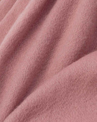 Close-up of a pink scarf, showcasing its soft texture and vibrant color.