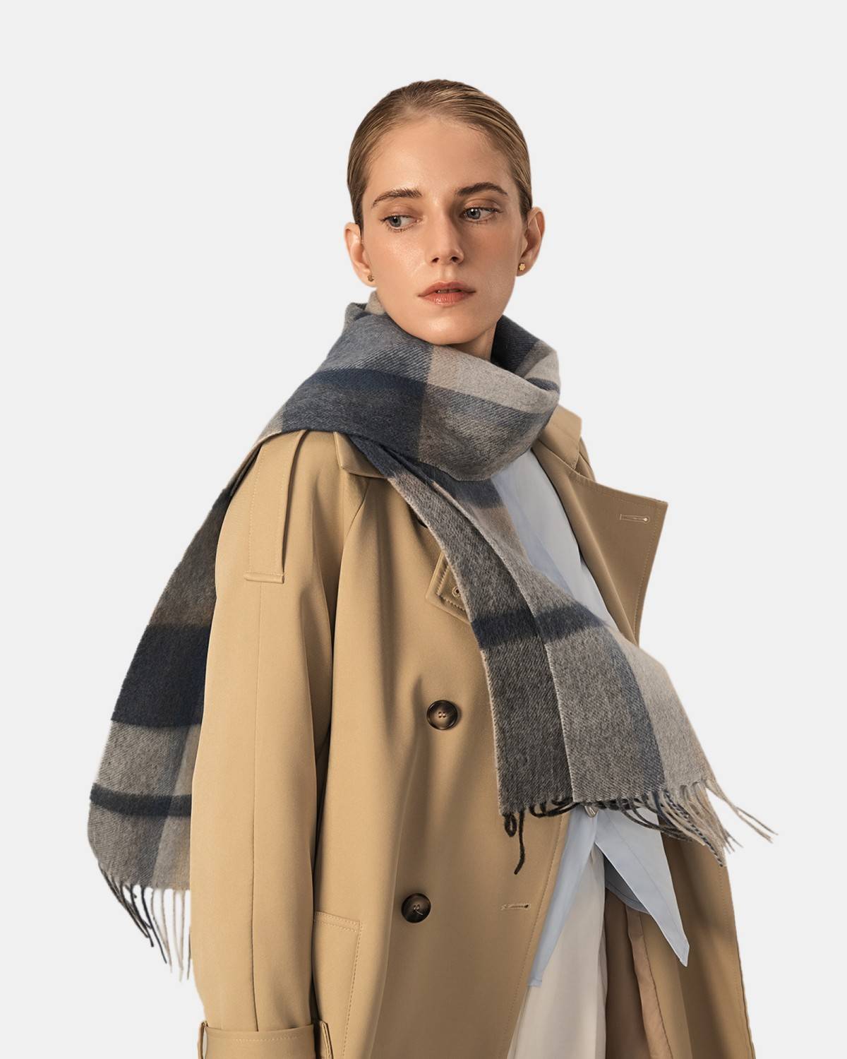 A model showcases a blue and gray classic winter scarf, perfect for keeping warm in chilly weather.