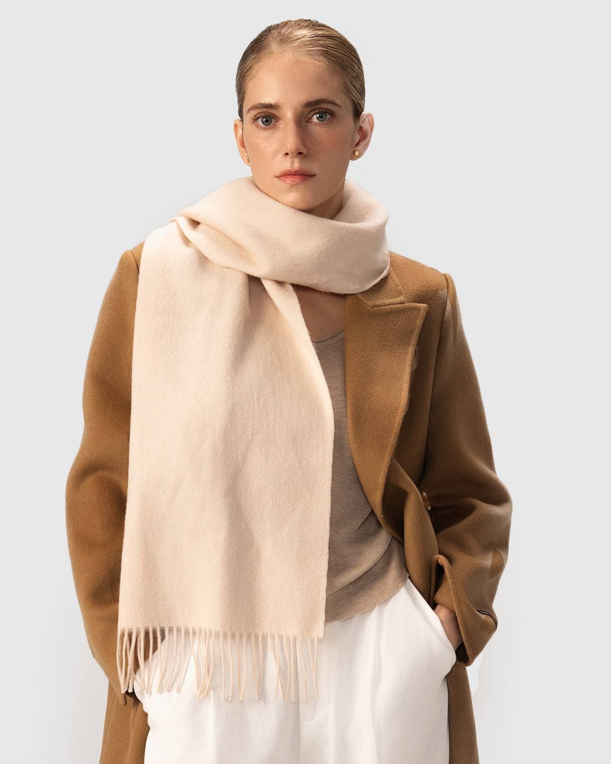 A luxurious beige wool scarf, perfect for winter, draped elegantly to showcase its soft texture and warmth.