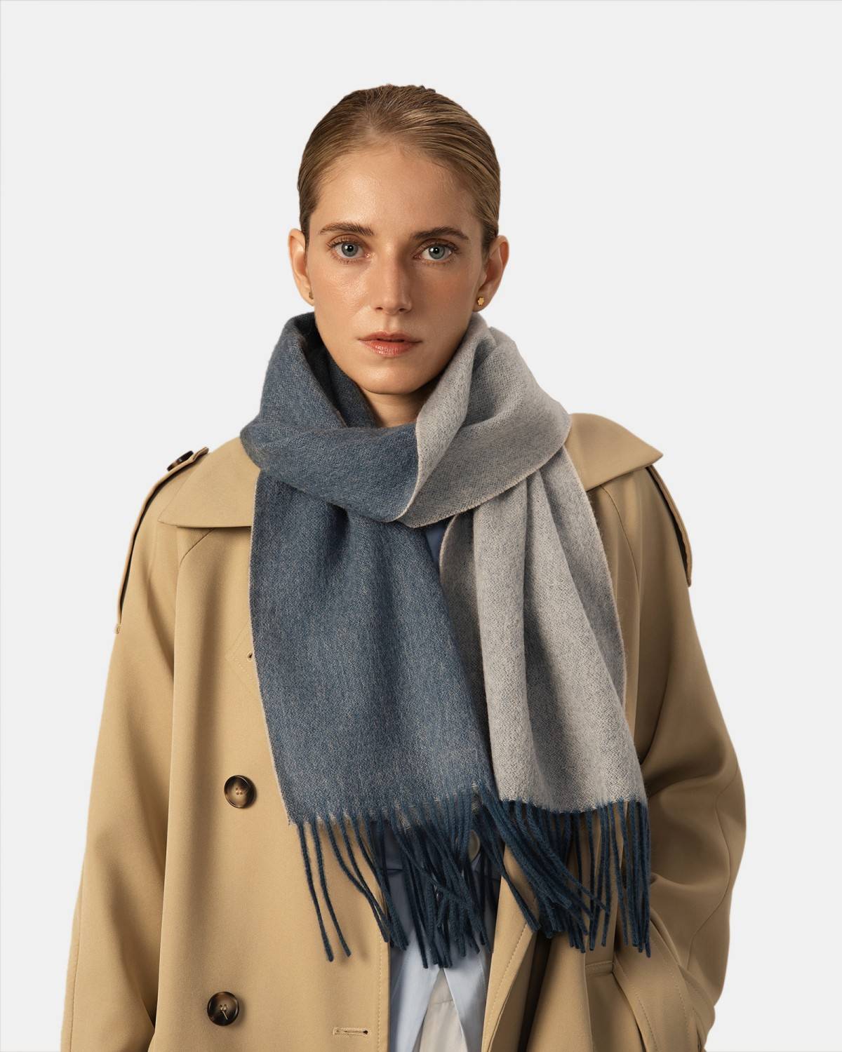 A model displays a reversible scarf crafted from two contrasting colors of wool, highlighting its fashionable appeal.