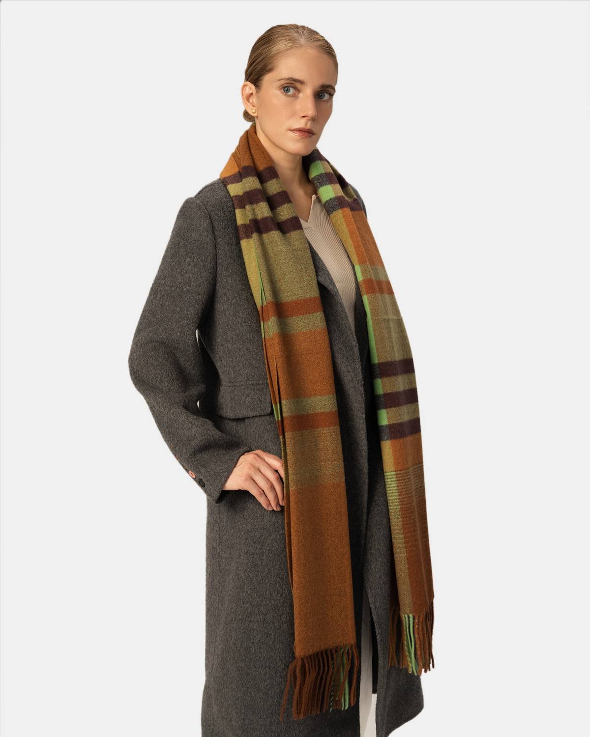A model showcases a stylish plaid check scarf, adding a pop of pattern to their outfit.